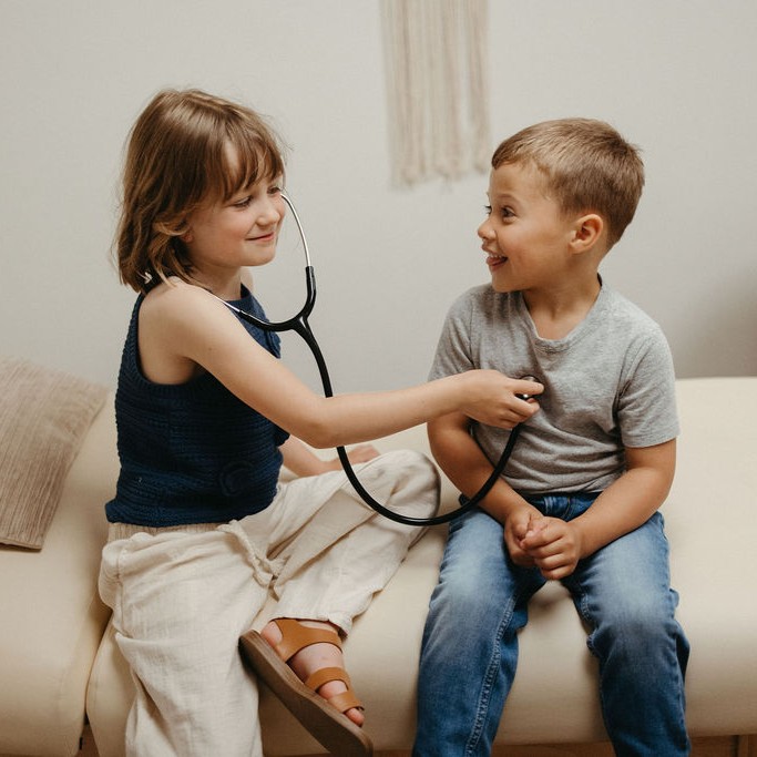Two children playing with a stethoscope